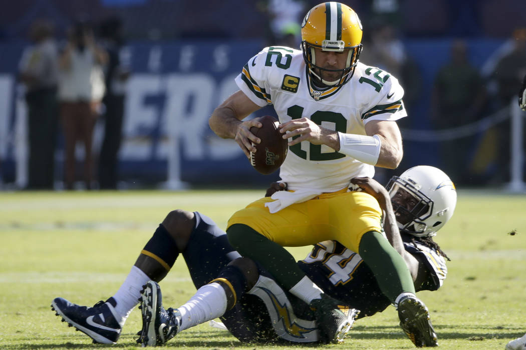 Green Bay Packers quarterback Aaron Rodgers is sacked by Los Angeles Chargers defensive end Mel ...