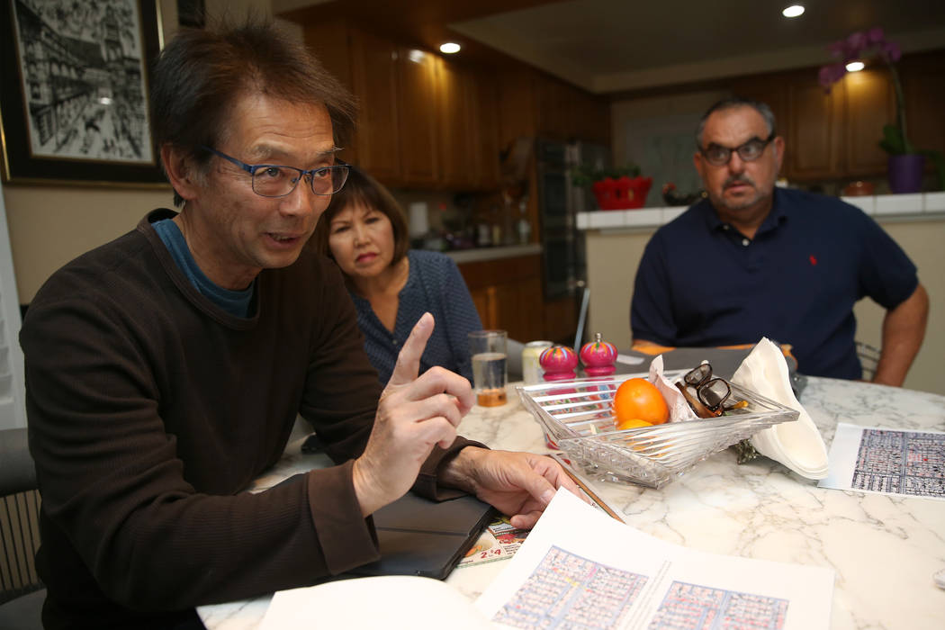 Wayne Niimi, from left, with his wife Lori, at the home of their neighbor Victor Padron, talk a ...