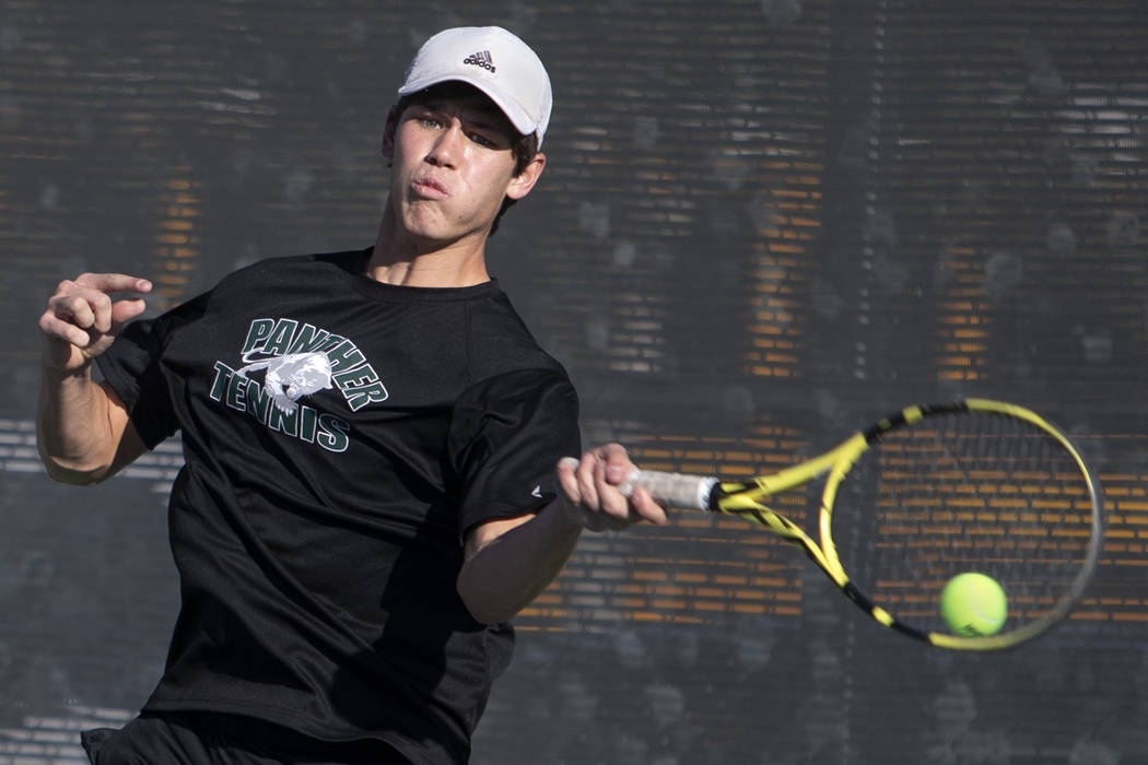 Palo Verde singles player Michael Andre hits the ball while playing Coronado's Tanner Phillips ...