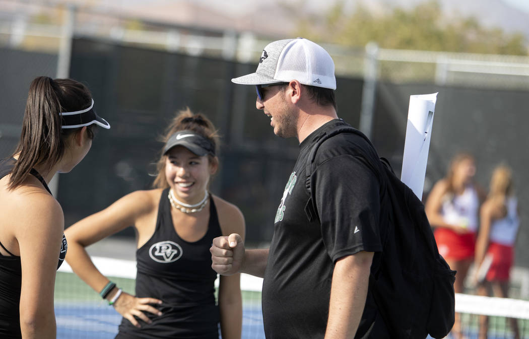 Palo Verde women's varsity tennis coach Tyler Marchant, right, encourages players Caroline Hsu, ...