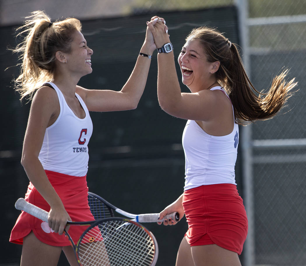 Coronado's Sofia Potomitis celebrates with her doubles partner Ava Nhiasi as they score a point ...