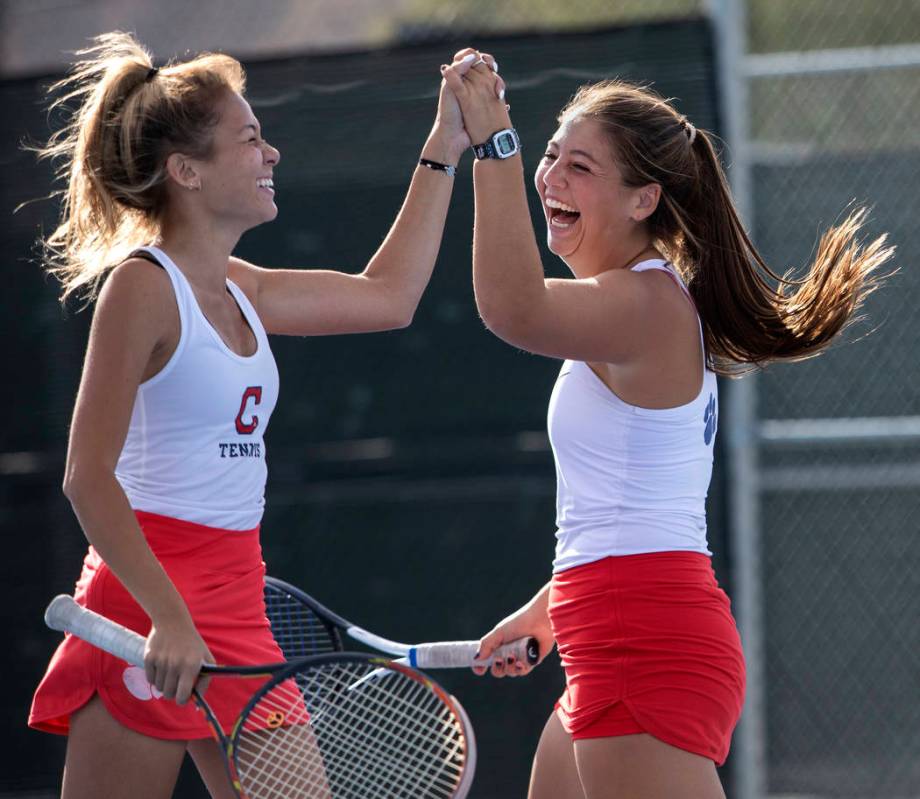 Coronado's Sofia Potomitis celebrates with her doubles partner Ava Nhiasi as they score a point ...