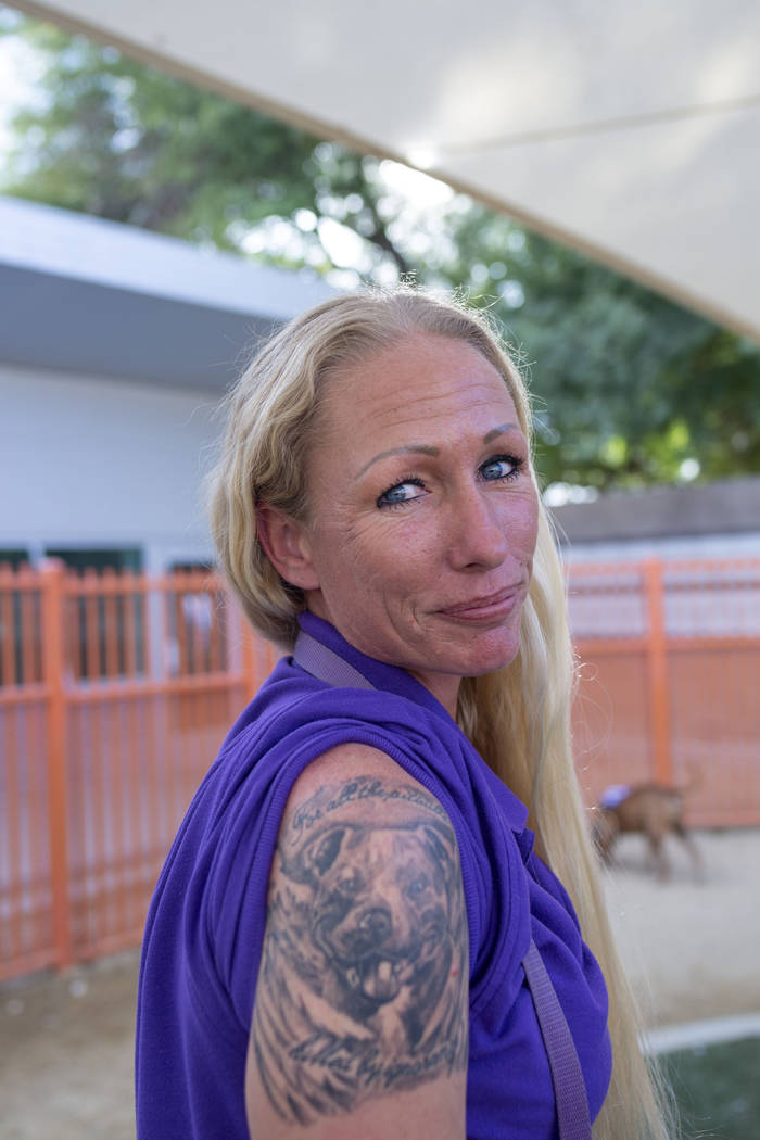 Nicole Fox, an enrichment specialist for the Animal Foundation, shows off her pitbull tattoo at ...