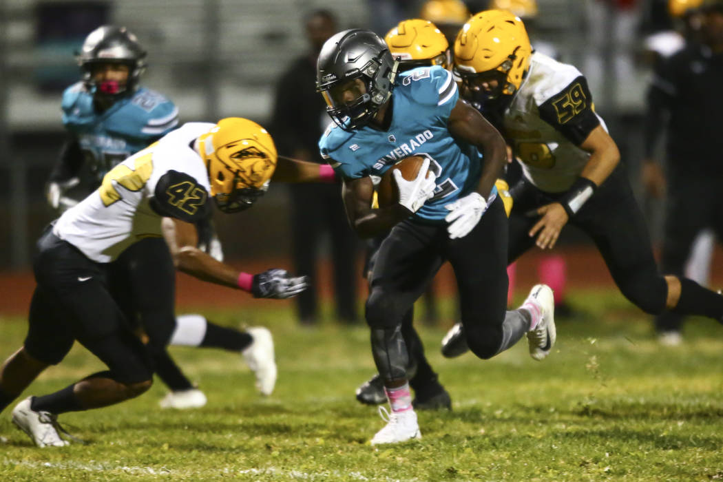 Silverado's Aginae Cunningham (2) runs the ball against Clark during the first half of a footba ...