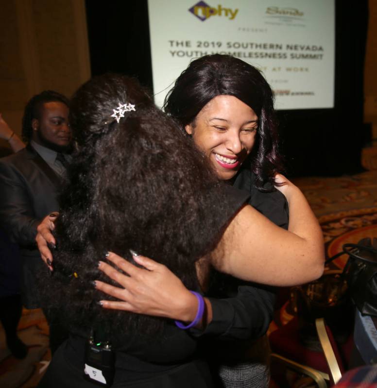 Tanya Smith, a course assistant at Nevada State College, right, hugs Nevada Partnership for Hom ...