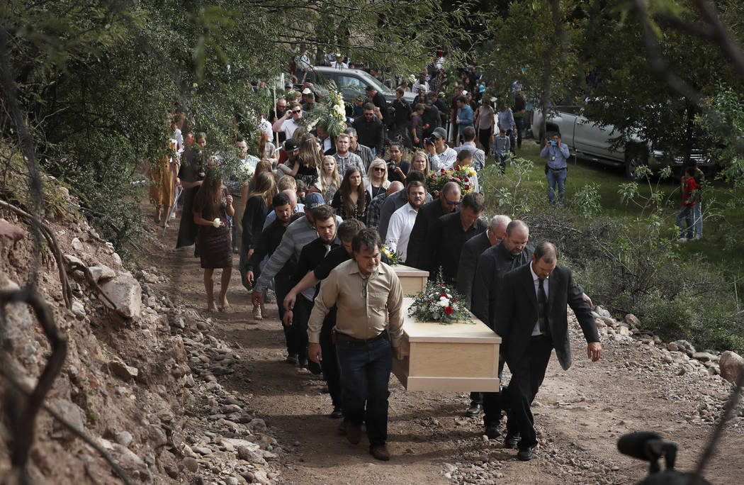 Family and friends carry the coffins that contain the remains of Dawna Ray Langford, 43, and he ...