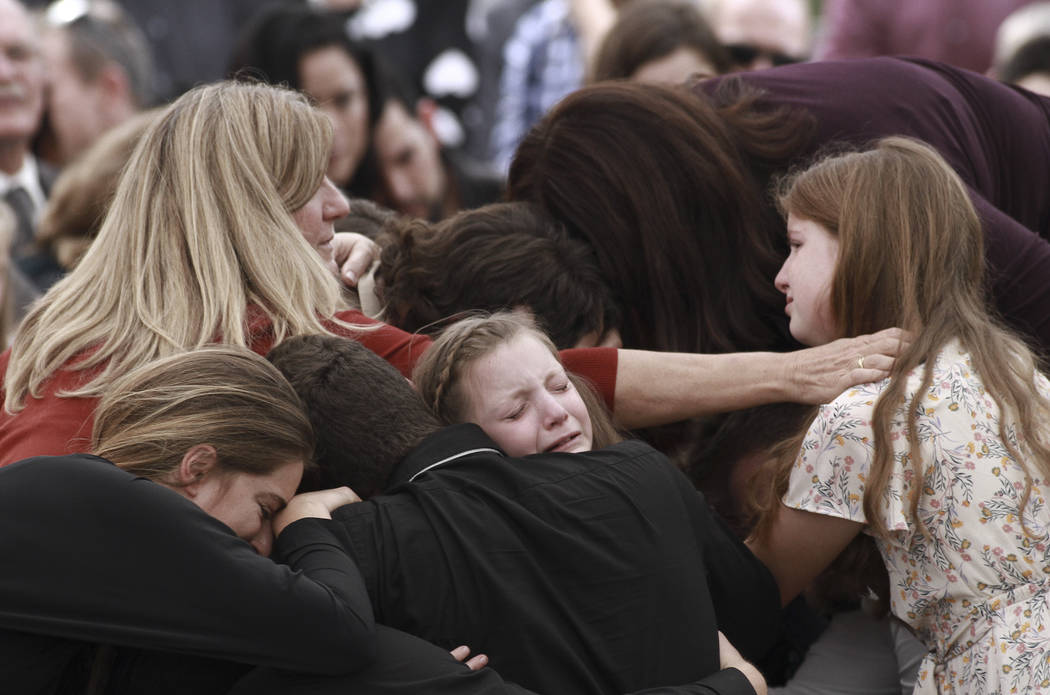 Family and friends weep during the funeral service for Dawna Ray Langford, 43, and her sons Tre ...