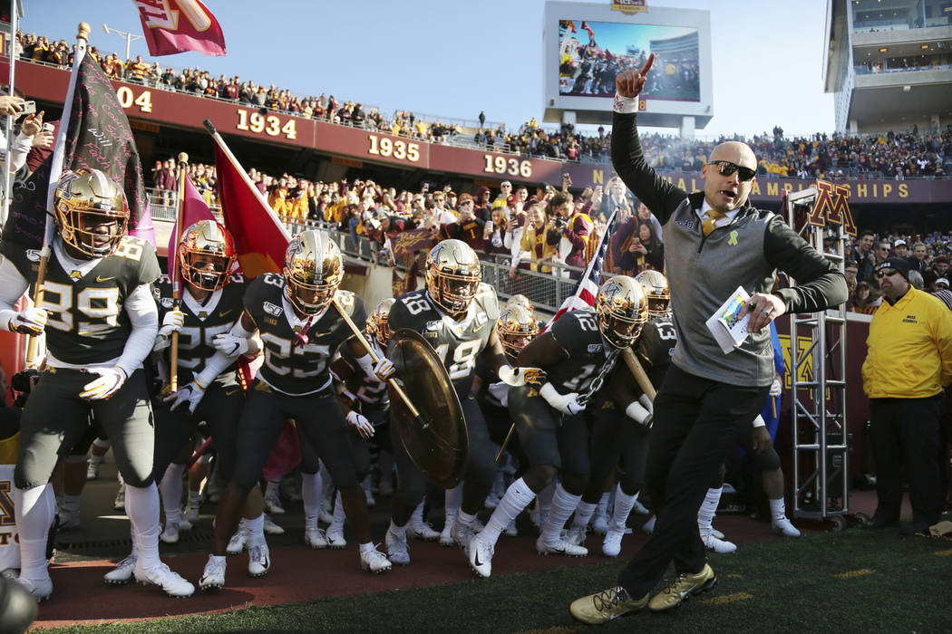 FILE - In this Oct. 26, 2019, file photo, Minnesota head coach P.J. Fleck leads him team on the ...