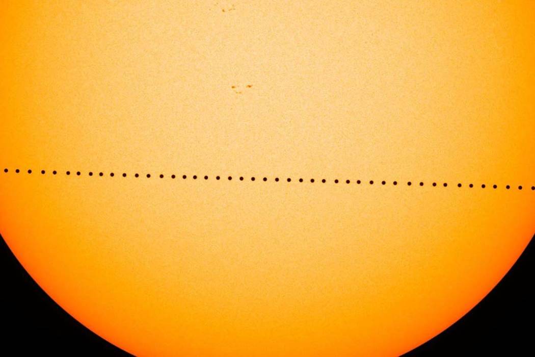 In a composite image provided by NASA, the planet Mercury passes directly between the sun and E ...