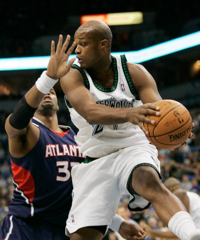 Minnesota Timberwolves forward Antonie Walker, right, pulls in a rebound in front of Atlanta Ha ...