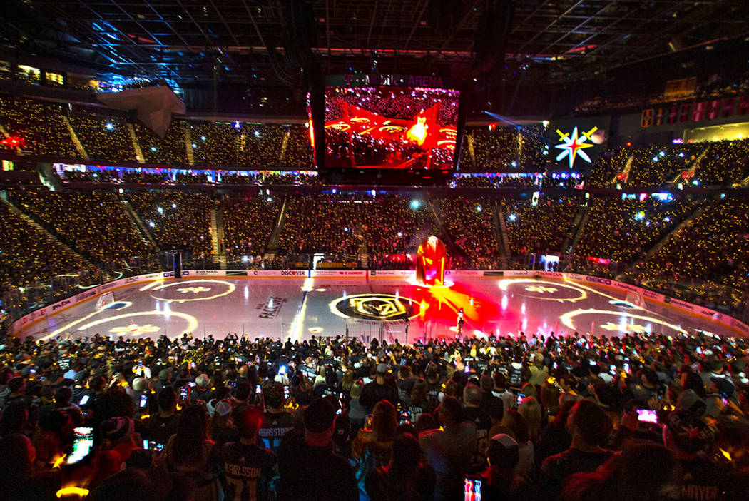 Lighted bracelets twinkle on the wrists of Vegas Golden Knights fans before the start of the fi ...