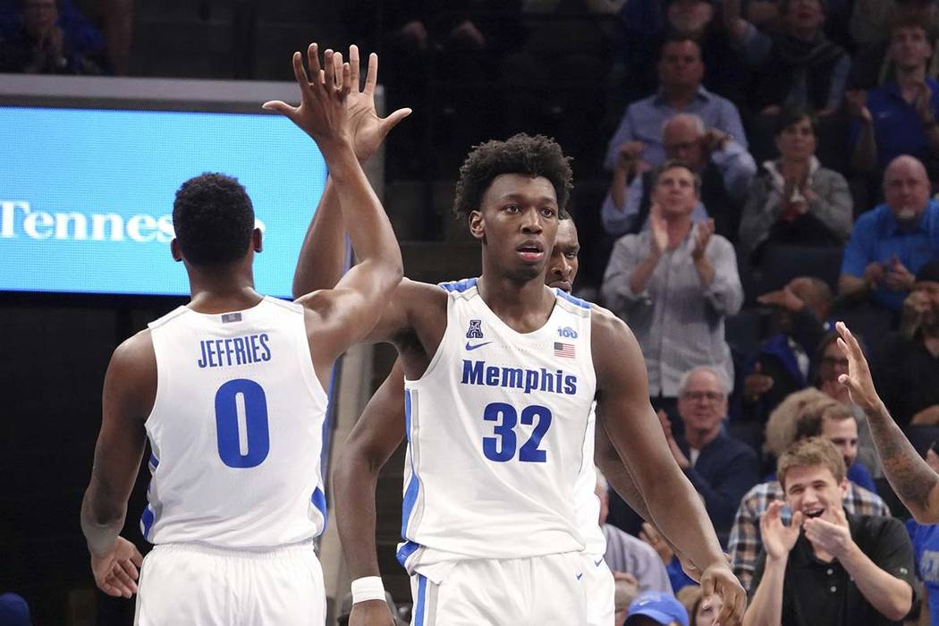 Memphis' James Wiseman (32) is congratulated by D.J. Jeffries (0) during the first half of an N ...