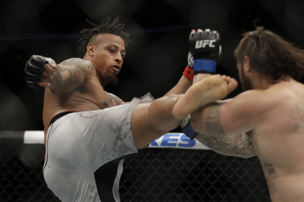 Greg Hardy kicks Ben Sosoli during a heavyweight mixed martial arts bout, Friday, Oct. 18, 2019 ...