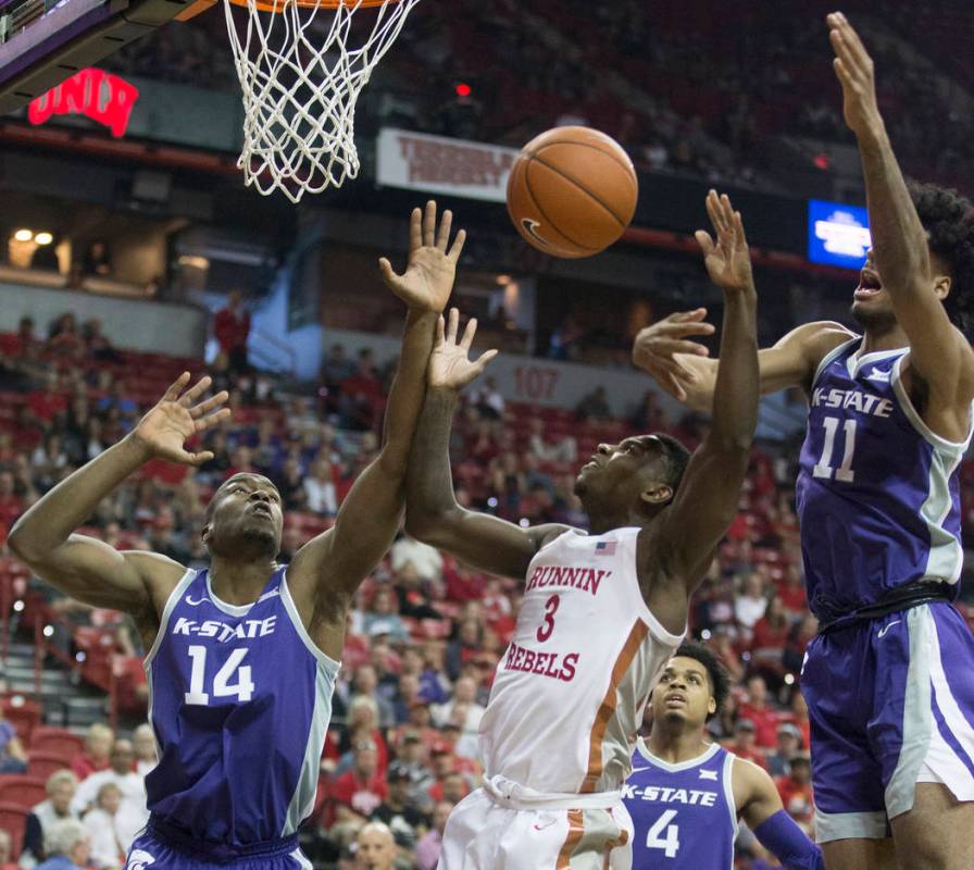 UNLV Rebels guard Amauri Hardy (3) fights for a loose ball with Kansas State Wildcats forward M ...