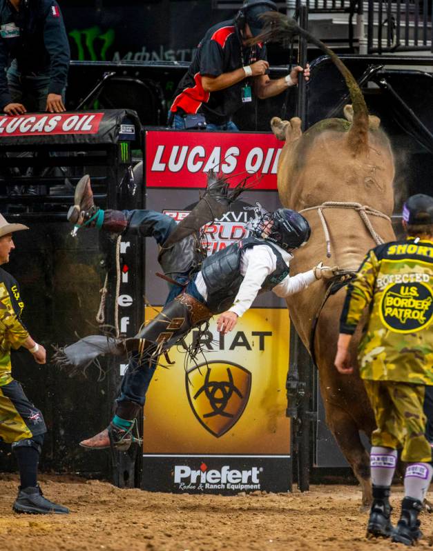 Austin Richardson hangs on to the rope while bucked off of Red Dawn during the third day of th ...