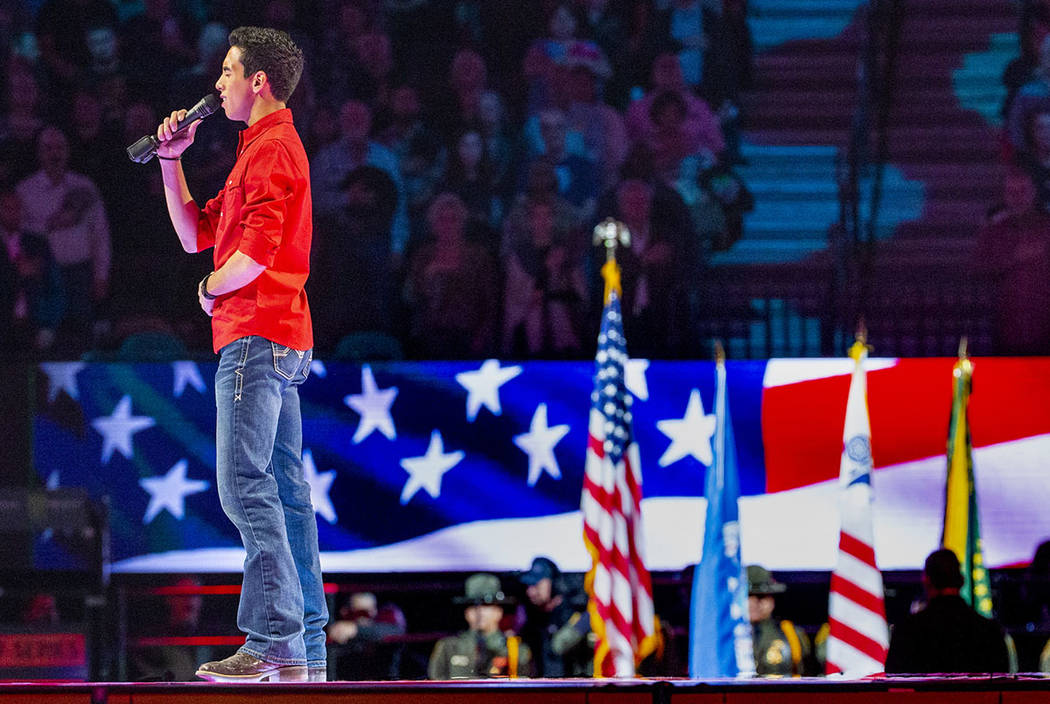 Antonio Moraes sings the National Anthem during the third day of the PBR World Finals at T-Mobi ...