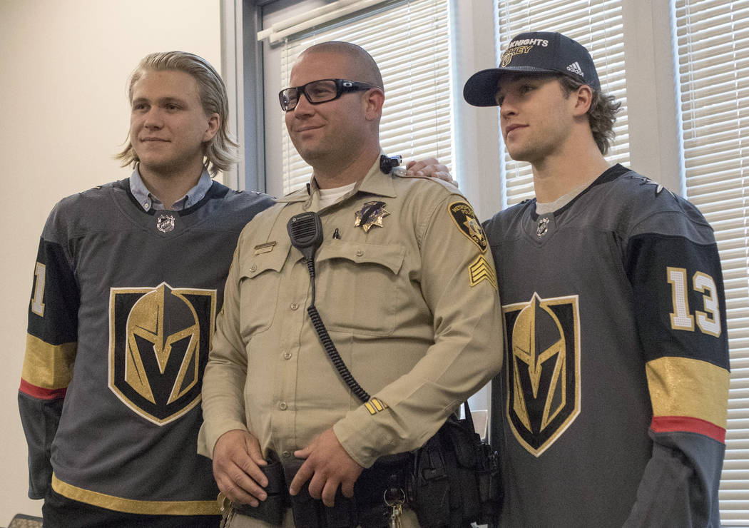 Vegas Golden Knights center William Karlsson (71), left, Metro sergeant Mike Calarco, center, a ...