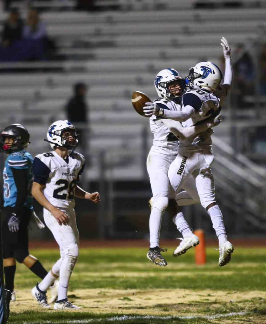 Foothill's Nathan Hargis (27) and Omari Canton (20) celebrate after breaking up a pass by Silve ...