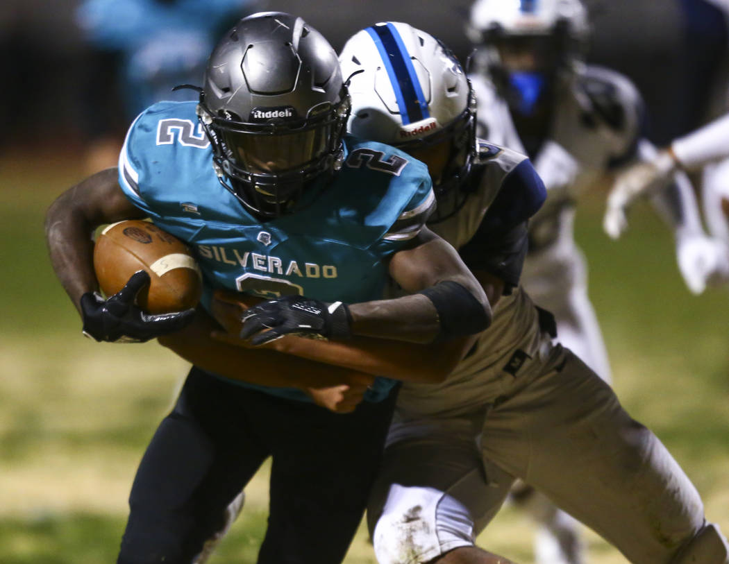 Foothill's Vyron Rosquist Wallace (23) tries to stop Silverado's Aginae Cunningham (2) on his w ...