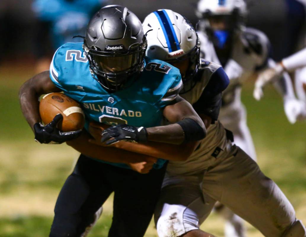 Foothill's Vyron Rosquist Wallace (23) tries to stop Silverado's Aginae Cunningham (2) on his w ...