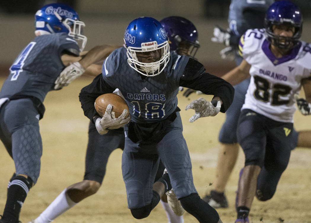 Green Valley's Carlen Wallace (18) breaks free for a big run past Durango's Tyson Guild (82) in ...