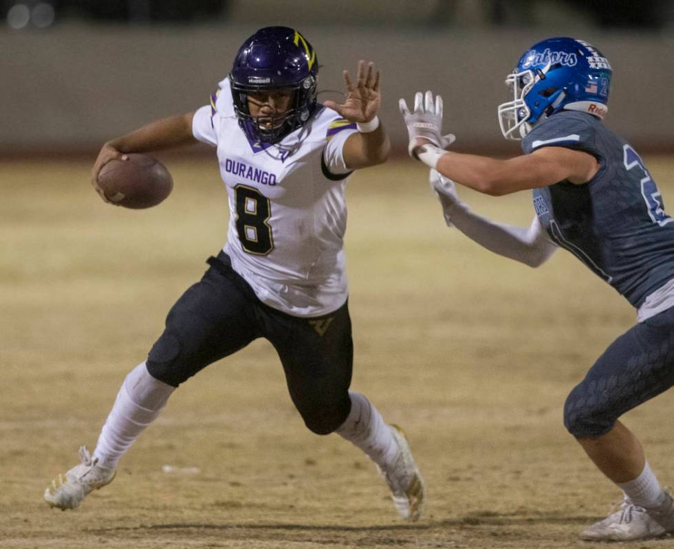 Durango's Ryan Cabase (8) stiff arm's Green Valley's Jacob Fedarko (21) in the first quarter on ...