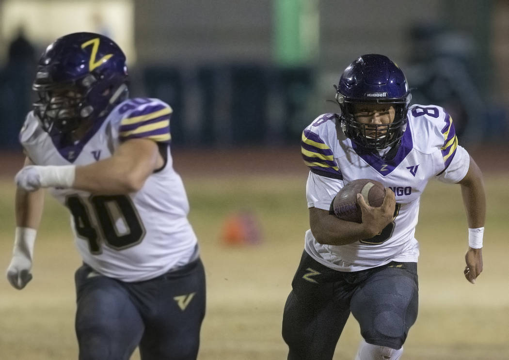 Durango's Ryan Cabase (8) scrambles for a first down with blocker Jayden Marquez (40) in the le ...