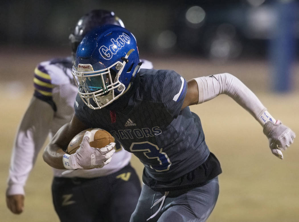 Durango's Jaxon Young (3) breaks free for a big gain past Durango's Steven Velazquez (61) in th ...