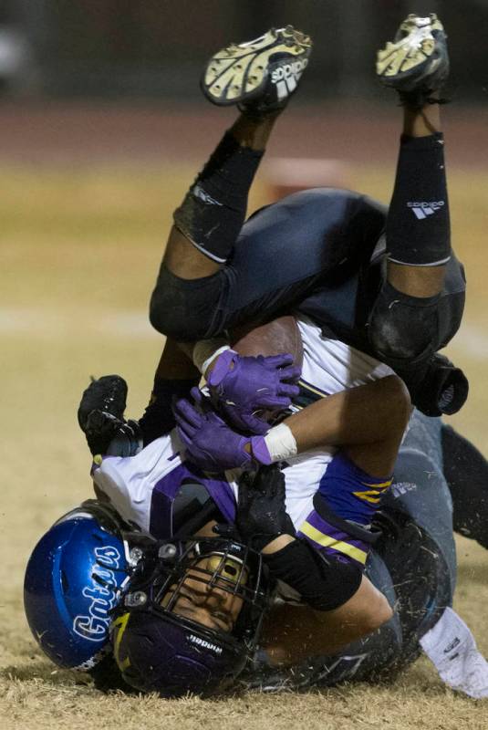 Durango's Jaxon Young (3) hits the ground hard with Green Valley's Stetler Harms (2) on his bac ...