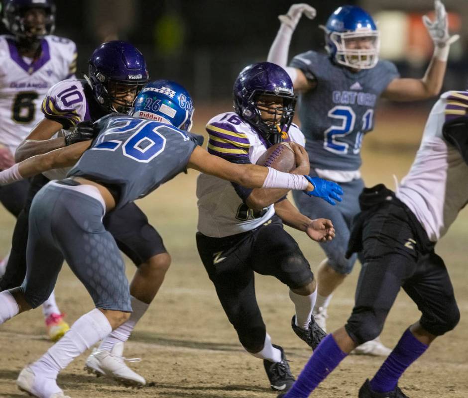 Durango's Sebastian Plascencia (16) tries to break the tackle of Green Valley's Anton Mazzulo ( ...