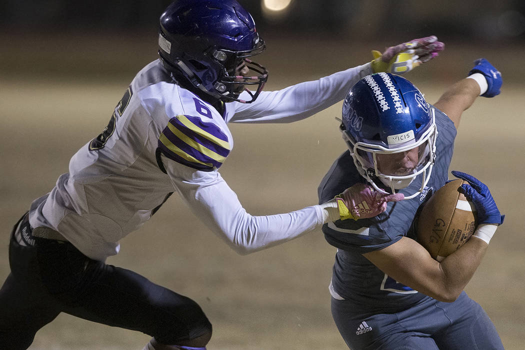 Green Valley's Noah Hawthorne (22) turns the corner past Durango's Michael Hayword (6) in the f ...