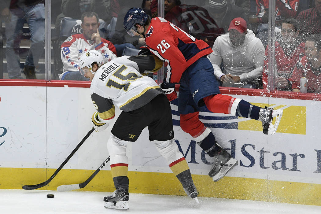 Washington Capitals center Nic Dowd (26) and Vegas Golden Knights defenseman Jon Merrill (15) c ...