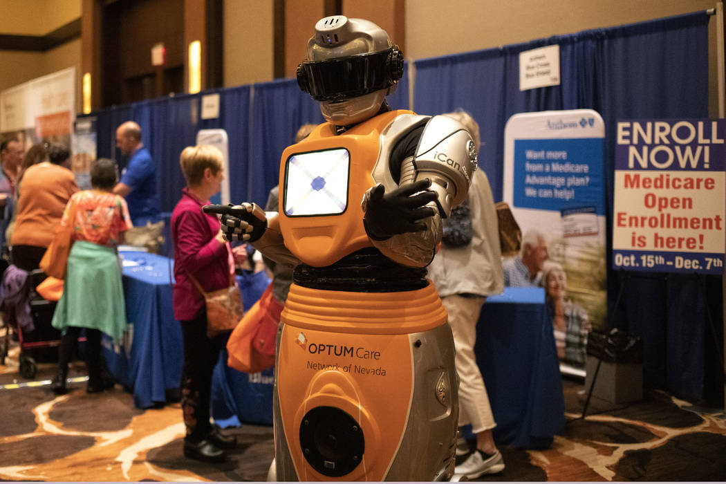 A robot brought by OptumCare interacts with attendants of the AgeWell Expo on Saturday, Nov. 9, ...