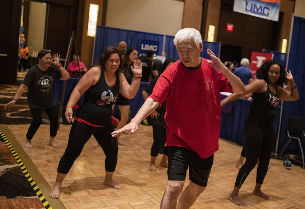Kunigh Takechi of Summerlin joins Hot Hula fitness for a work out at the AgeWell Expo on Saturd ...