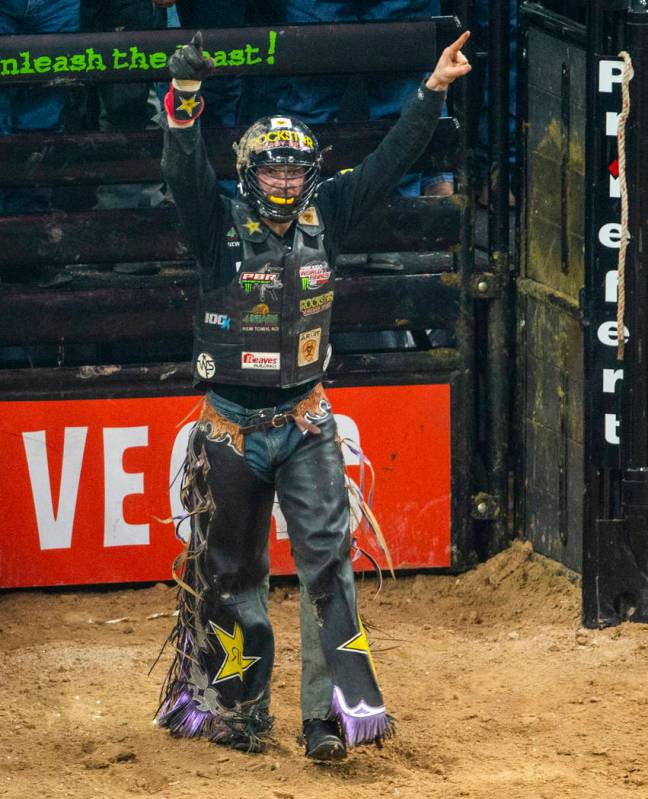 Matt Triplett celebrates his successful ride on Sun Country during the third day of the PBR Wor ...