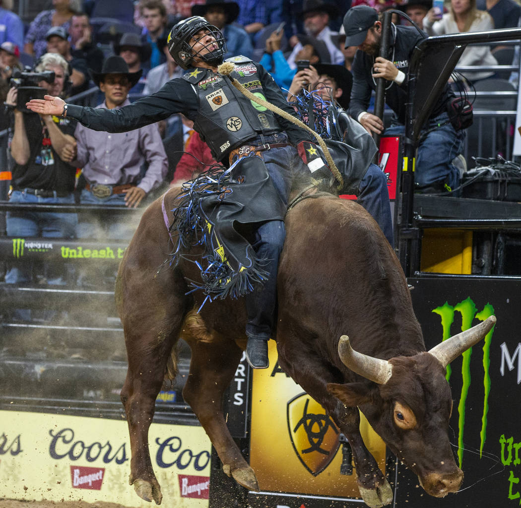 Luciano De Castro sits back atop of Rusty Bones during the fourth day of the PBR World Finals a ...