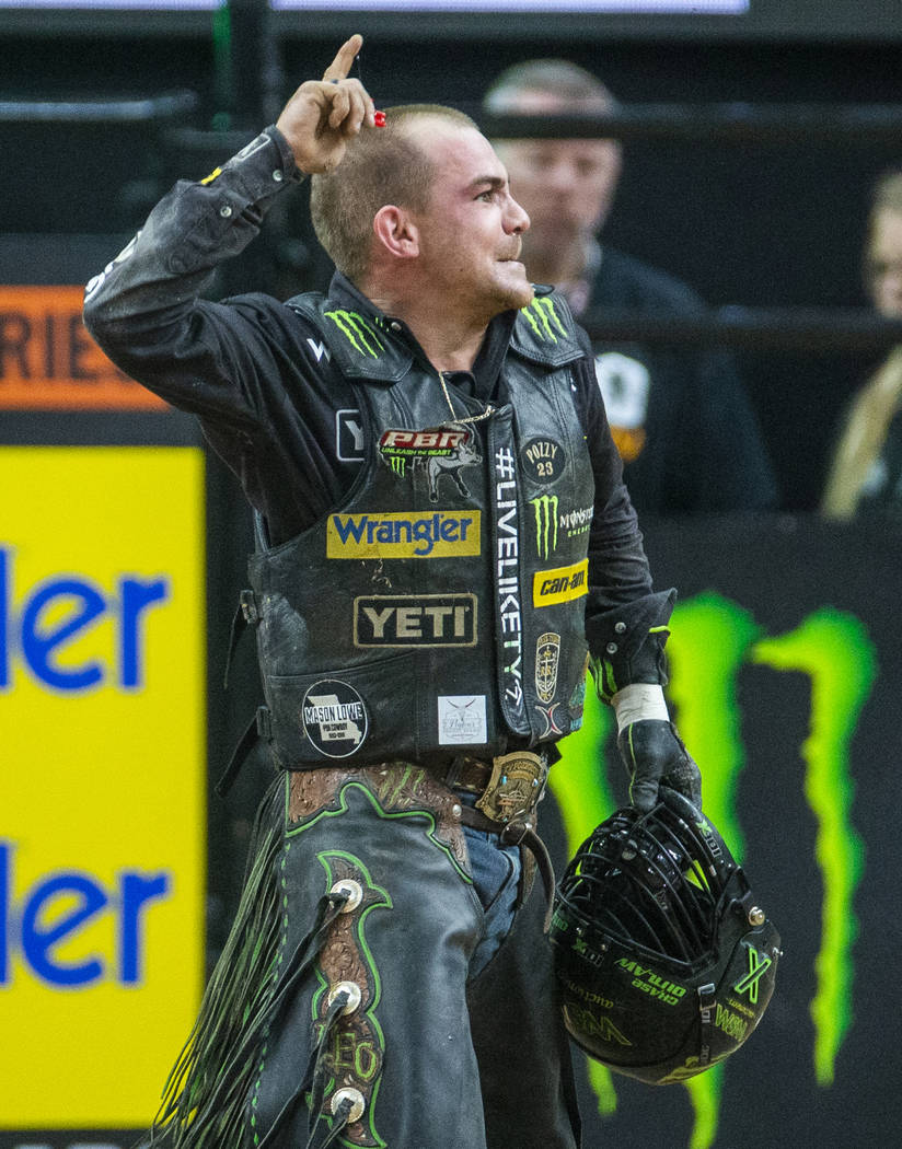 Chase Outlaw celebrates a successful ride on Catch My Drift during the fourth day of the PBR Wo ...