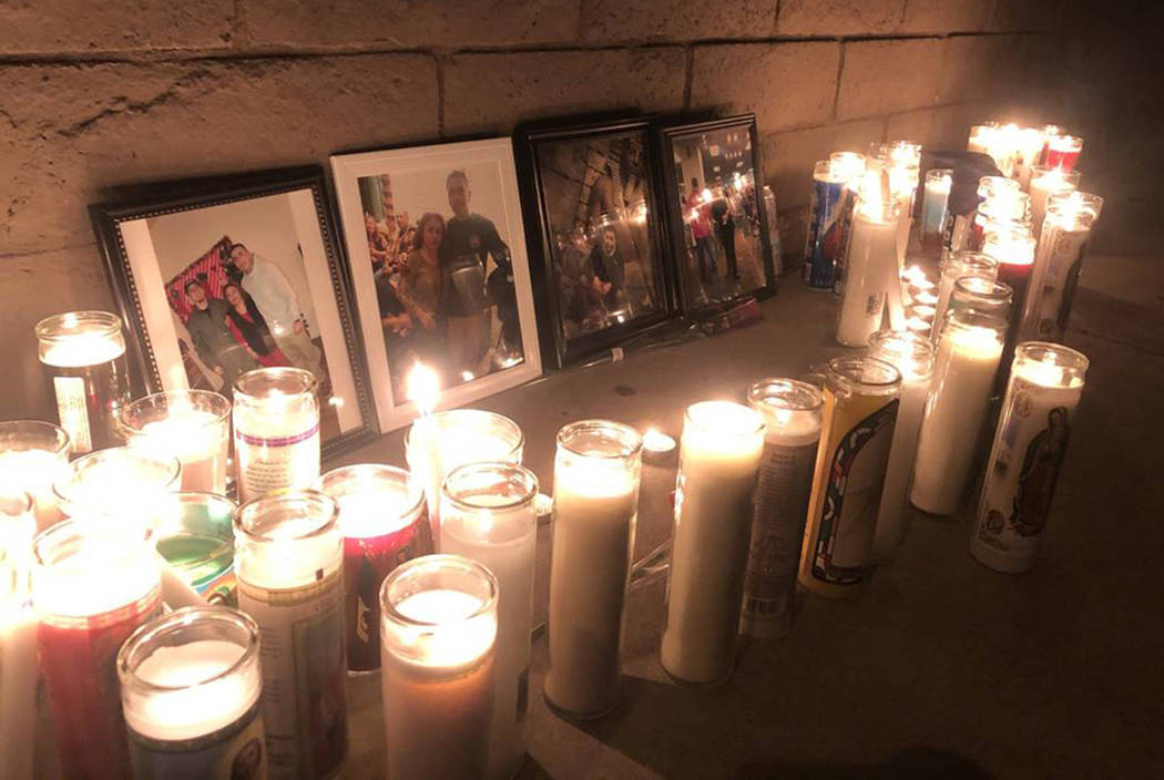 Pictures of 24-year-old Marco Antonio Alvizo are surrounded by religious candles on Friday, Oct ...