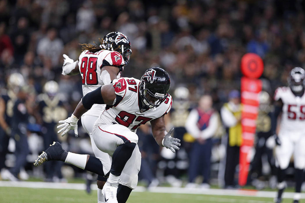 Atlanta Falcons defensive tackle Grady Jarrett (97) celebrates his sack with defensive end Takk ...