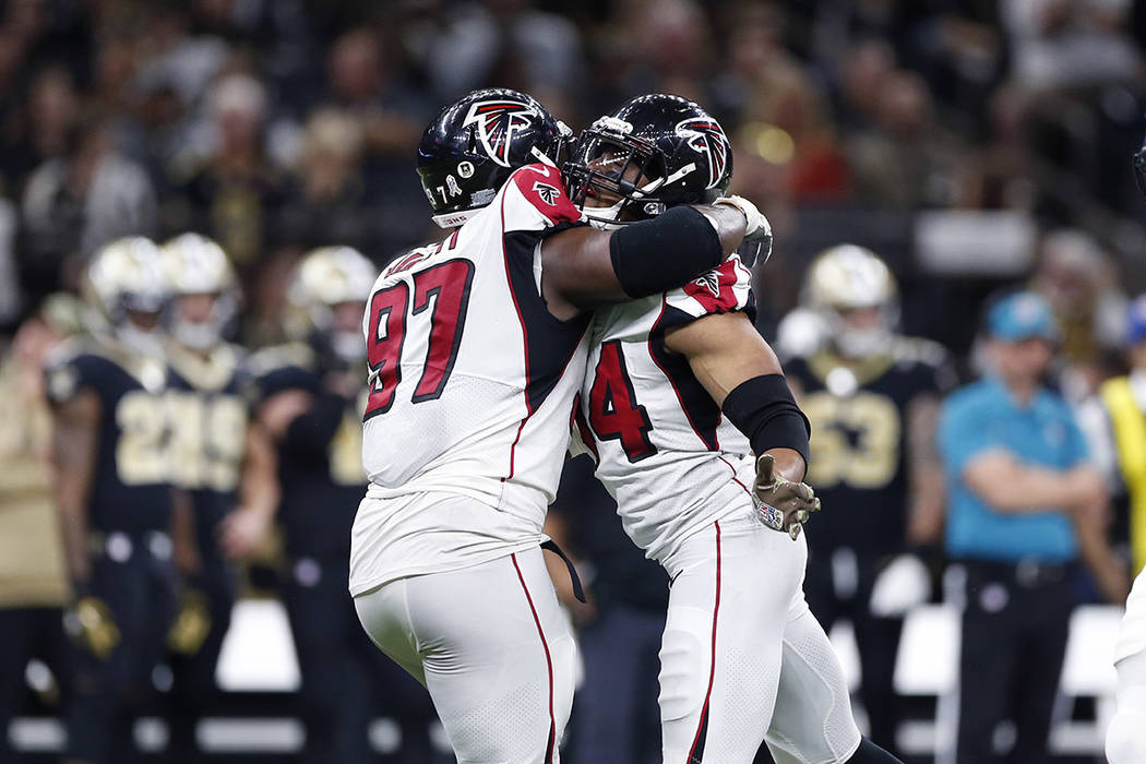 Atlanta Falcons defensive end Vic Beasley (44) celebrates his sack with defensive tackle Grady ...