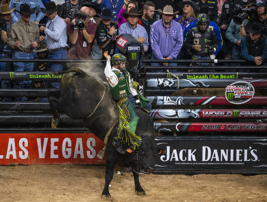 Jess Lockwood rides tall on Rising Sun during the last day of the PBR World Finals at T-Mobile ...