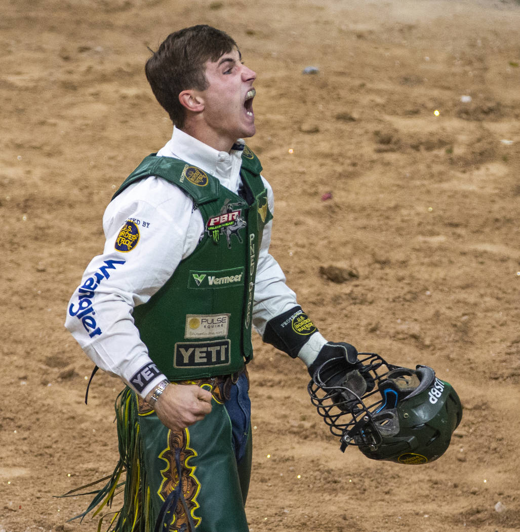 Jess Lockwood celebrates a successful ride on Rising Sun during the last day of the PBR World F ...
