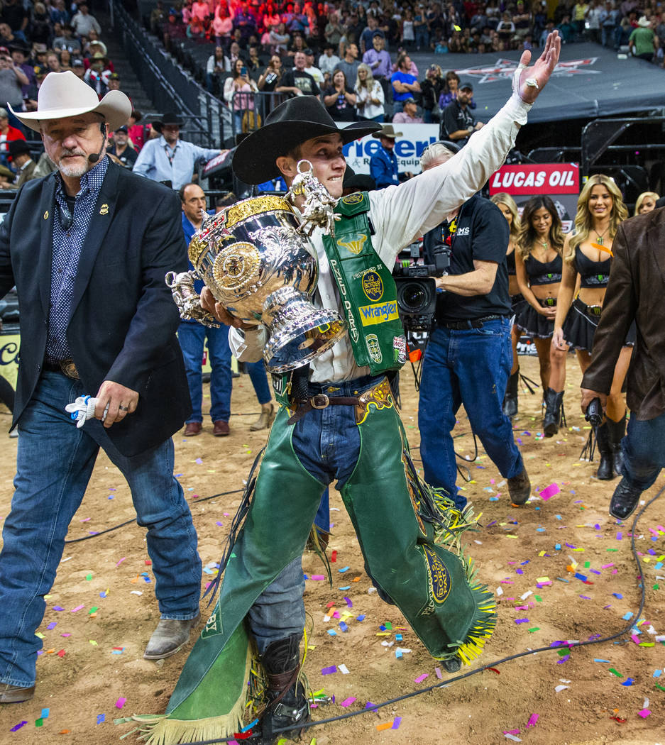 Jess Lockwood walks with his winning trophy after being awarded the 2019 PBR World Finals Champ ...