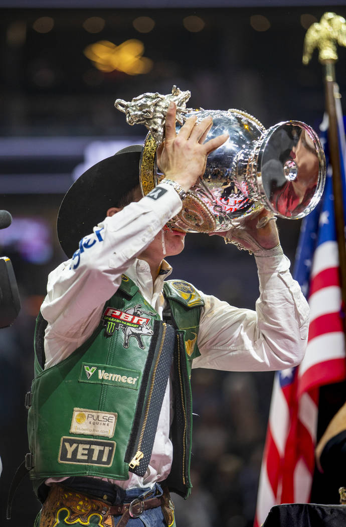 Jess Lockwood drinks a Coors beer from his winning trophy after being awarded the 2019 PBR Worl ...