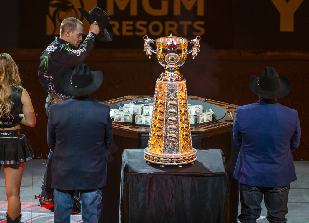 Chase Outlaw arrives on stage during introductions and eyes the cash and winning trophy on the ...