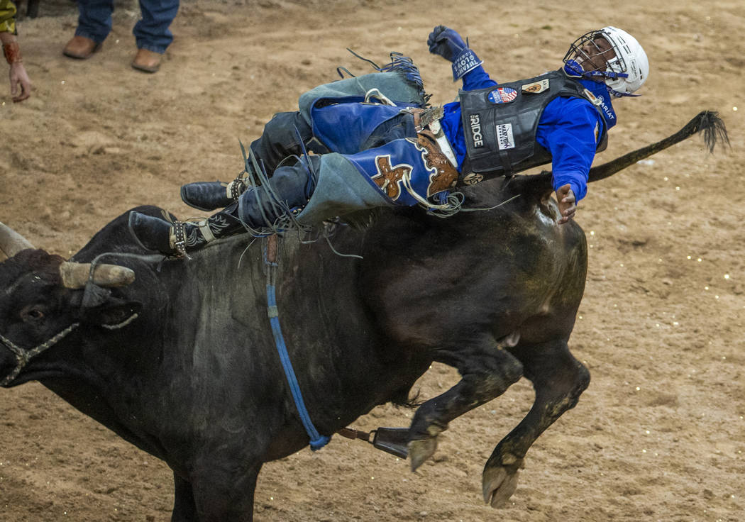 Ezekiel Mitchell is bucked back off of Medicine Man during the last day of the PBR World Final ...