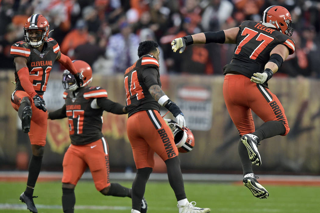 Cleveland Browns cornerback Denzel Ward (21) and teammates celebrate after they defeated the Bu ...