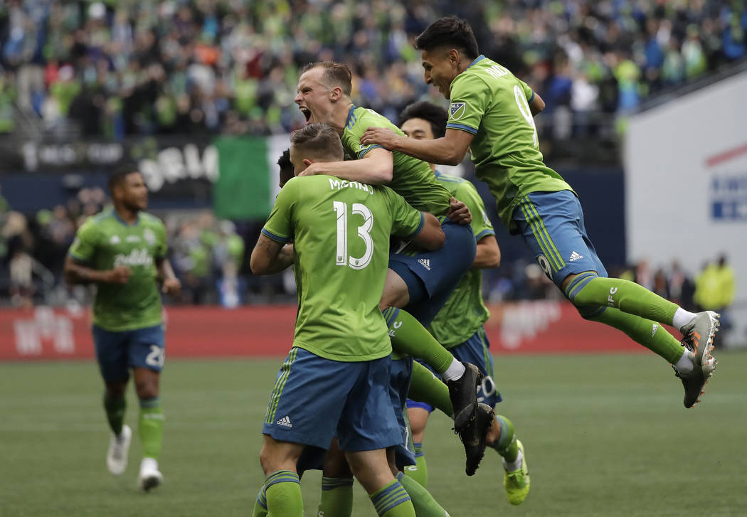 Seattle Sounders celebrate after Kelvin Leerdam scored against the Toronto FC, Sunday, Nov. 10, ...