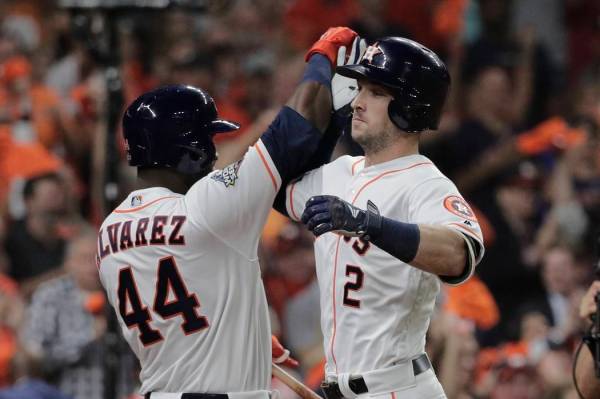 Houston Astros' Alex Bregman is congratulated by Yordan Alvarez after hitting a home run during ...