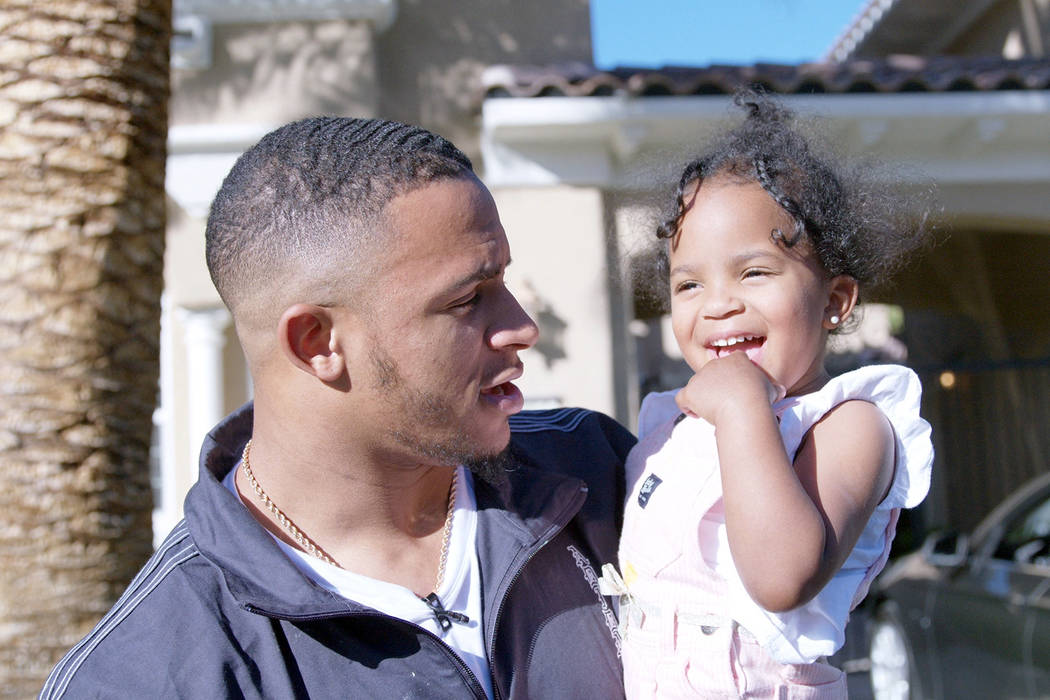 Raiders rookie safety Johnathan Abram holds his 2-year-old daughter, Harlee, while house huntin ...